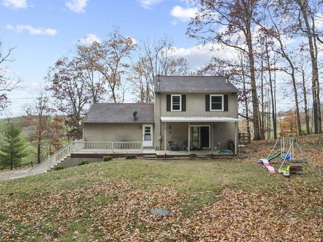 back of house with a lawn