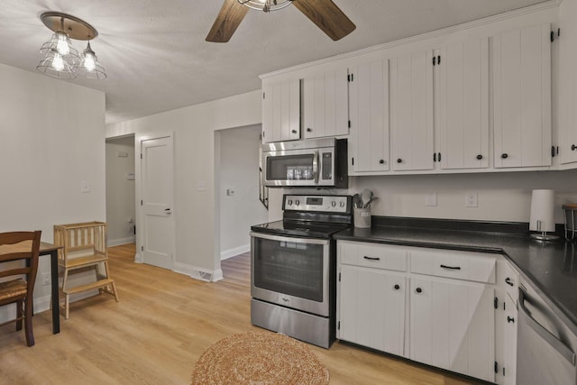 kitchen with ceiling fan, stainless steel appliances, light hardwood / wood-style flooring, and white cabinets