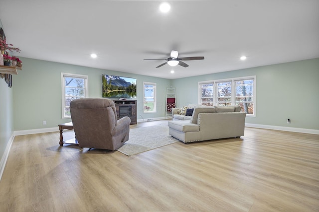 living room featuring ceiling fan and light wood-type flooring