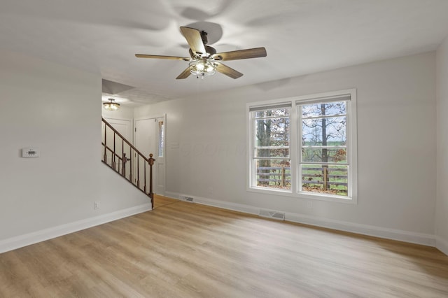 empty room with light hardwood / wood-style floors and ceiling fan