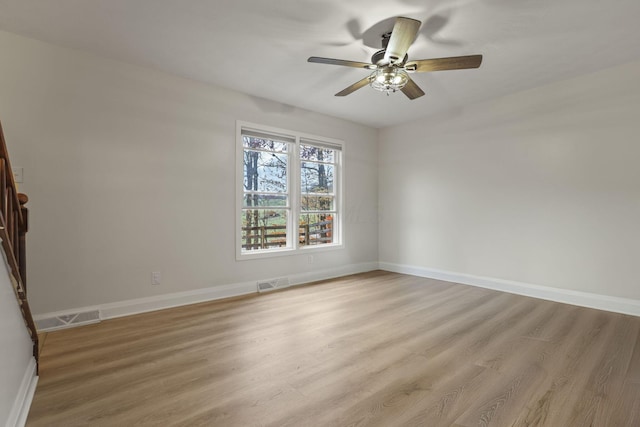 empty room with ceiling fan and light wood-type flooring