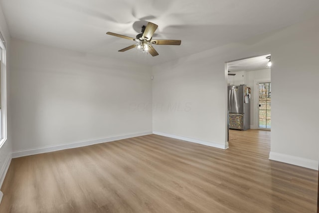 spare room featuring ceiling fan and light hardwood / wood-style flooring