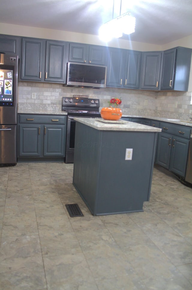 kitchen featuring decorative backsplash, a center island, and stainless steel appliances