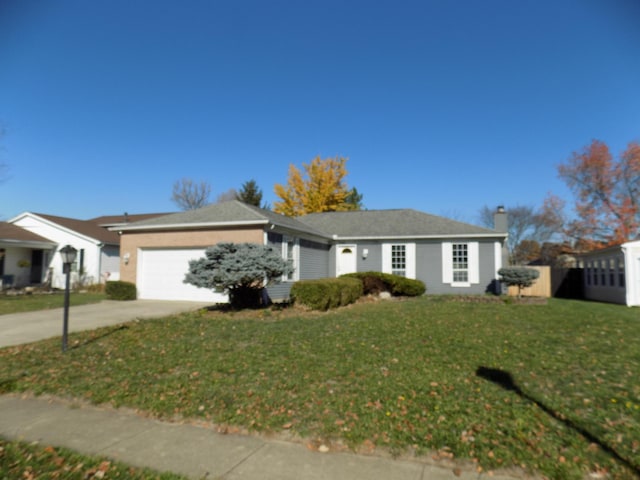 single story home with a garage and a front lawn