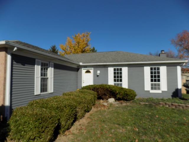 ranch-style house with a front lawn