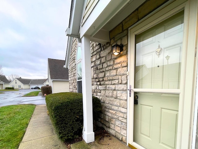 doorway to property with stone siding