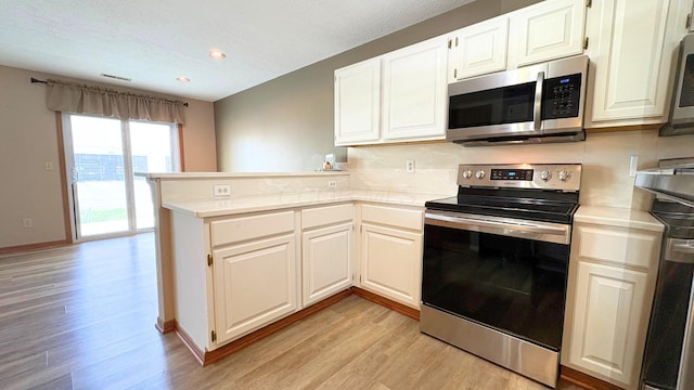 7837 Farmsbury Dr, Reynoldsburg, OH 43068 - kitchen with visible vents, appliances with stainless steel finishes, light countertops, a peninsula, and light wood-style floors