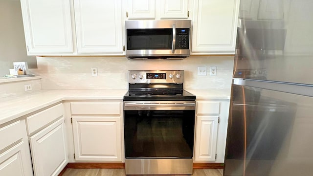 7837 Farmsbury Dr, Reynoldsburg, OH 43068 - kitchen with light countertops, white cabinets, and appliances with stainless steel finishes
