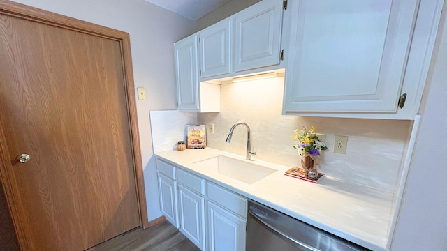 7837 Farmsbury Dr, Reynoldsburg, OH 43068 - kitchen with stainless steel dishwasher, wood finished floors, a sink, light countertops, and white cabinets
