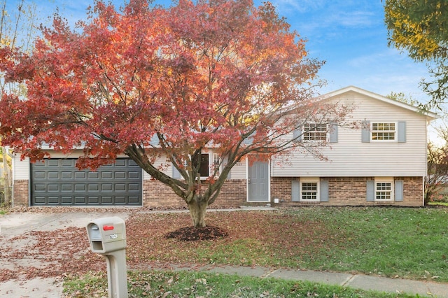 view of front of house with a garage and a front lawn