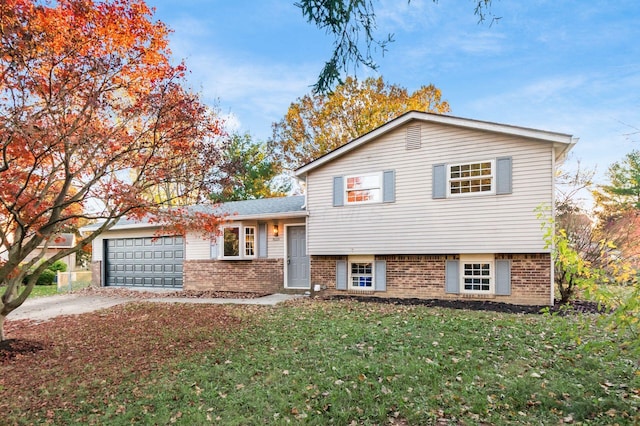 split level home featuring a garage and a front lawn