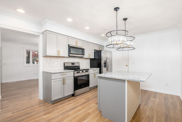 kitchen featuring light stone countertops, stainless steel appliances, and gray cabinets