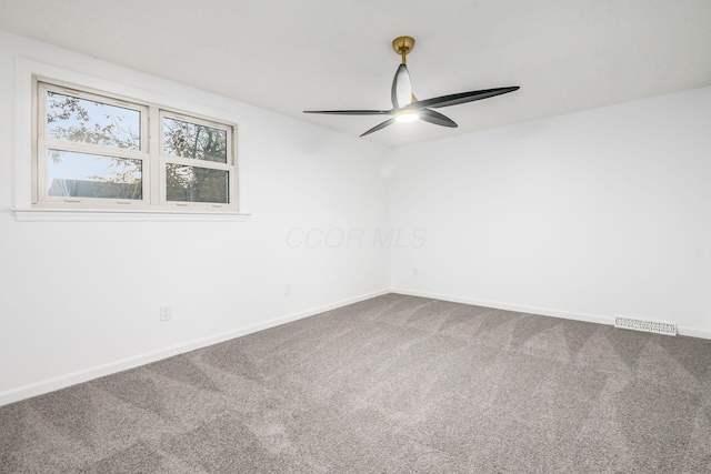 carpeted spare room featuring ceiling fan