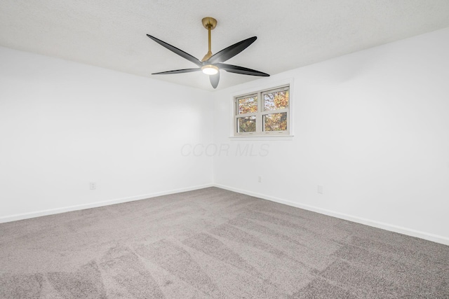 spare room featuring carpet and ceiling fan