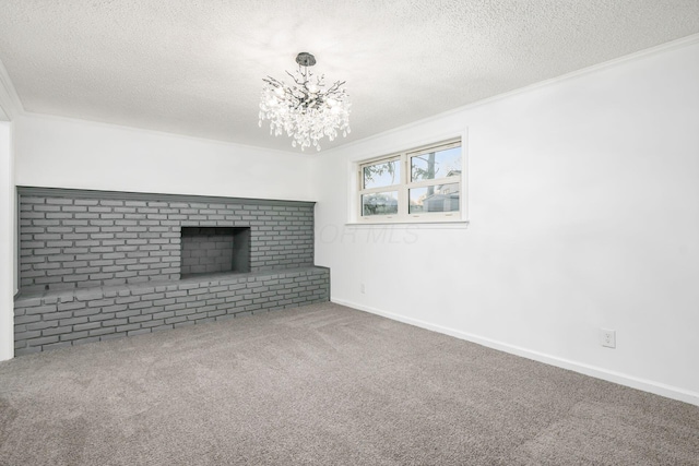 unfurnished living room with carpet, ornamental molding, a textured ceiling, and a notable chandelier