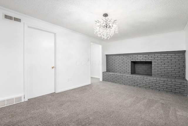 unfurnished living room with crown molding, carpet, a textured ceiling, and an inviting chandelier