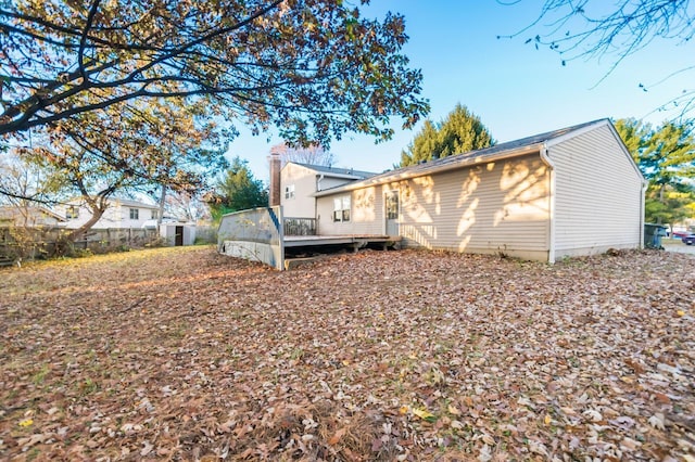 back of house with a wooden deck