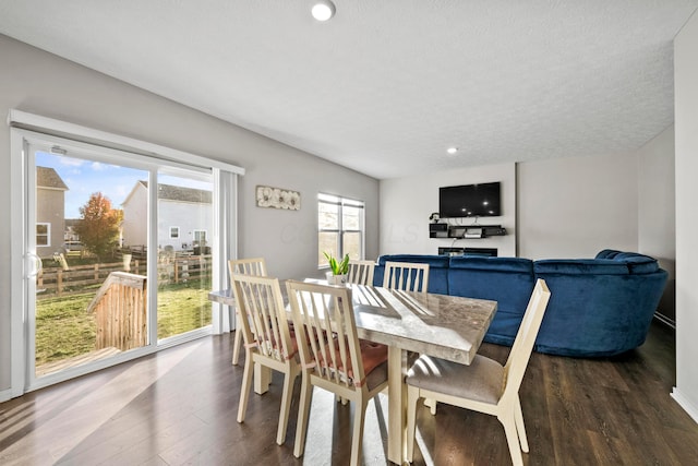 dining area with hardwood / wood-style flooring and a textured ceiling