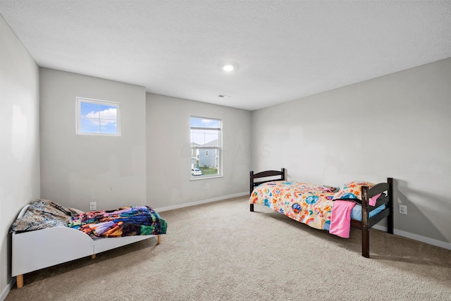 carpeted bedroom featuring a textured ceiling