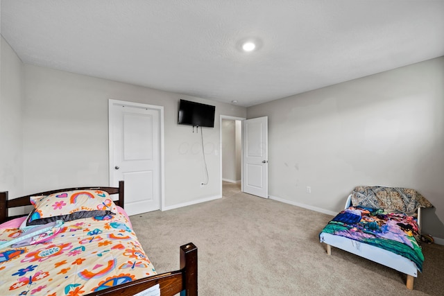 bedroom with carpet and a textured ceiling