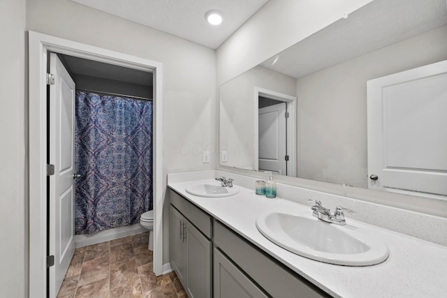 full bathroom with vanity, toilet, and shower / bath combo with shower curtain