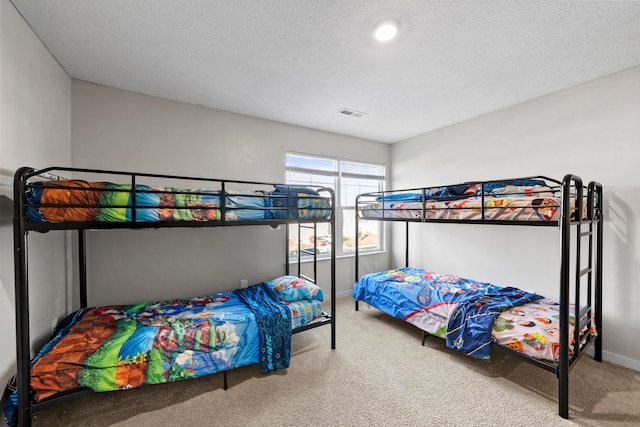 carpeted bedroom with a textured ceiling