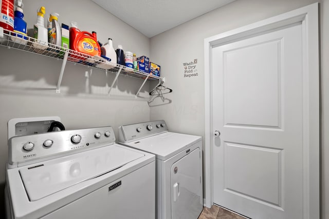 laundry area featuring washing machine and dryer and a textured ceiling