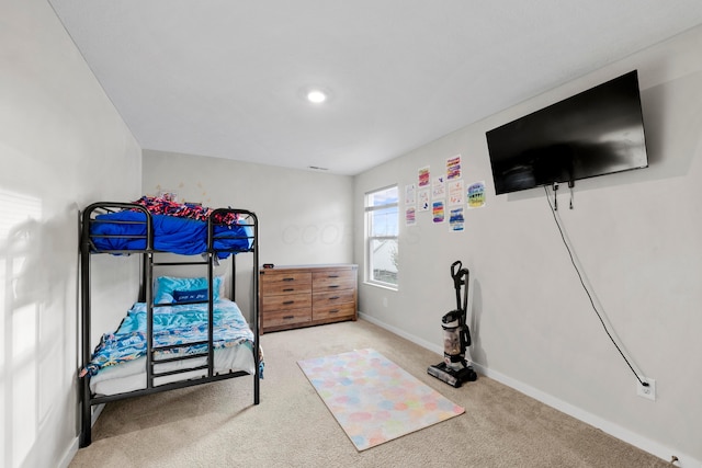 bedroom featuring light carpet