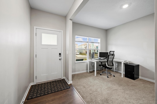 office with a textured ceiling and dark hardwood / wood-style floors