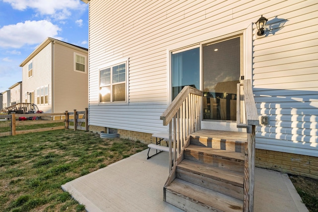 property entrance with a patio area and a yard