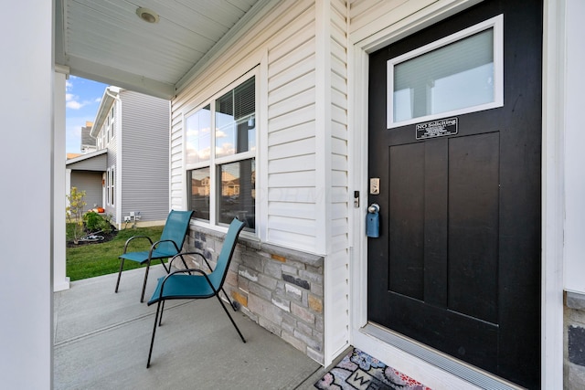 view of exterior entry with covered porch