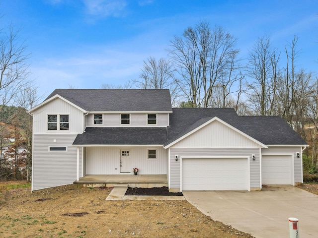 view of front of property with a porch, an attached garage, driveway, and a shingled roof