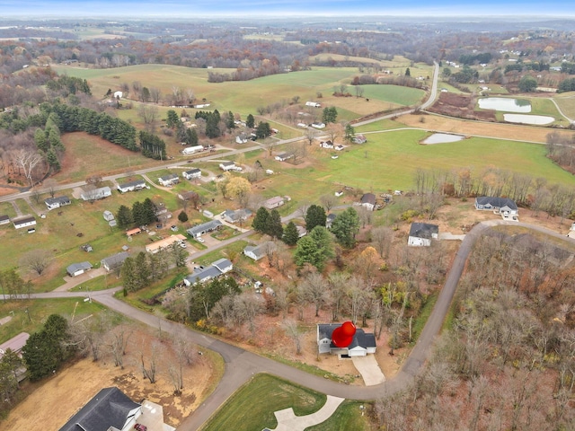 birds eye view of property with a rural view