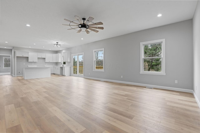 unfurnished living room featuring light wood-style floors, recessed lighting, baseboards, and a ceiling fan