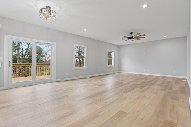 unfurnished living room featuring light wood-style flooring, baseboards, and recessed lighting