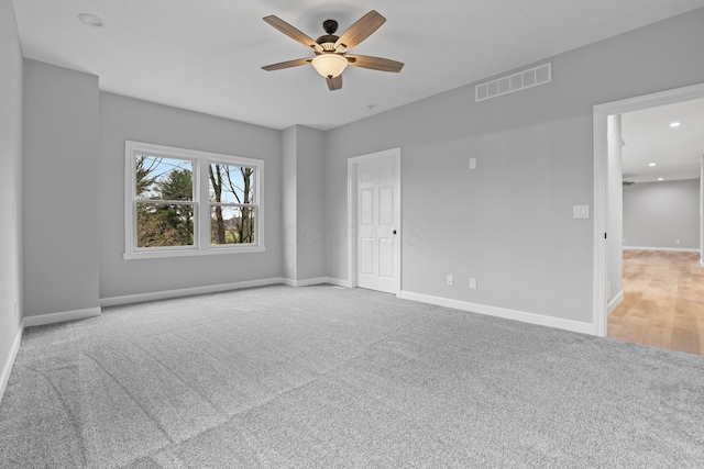 unfurnished room featuring a ceiling fan, carpet, visible vents, and baseboards