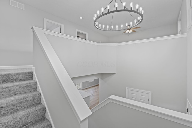 stairs with baseboards, visible vents, carpet floors, a notable chandelier, and recessed lighting