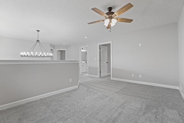 unfurnished room with ceiling fan with notable chandelier, recessed lighting, carpet flooring, and baseboards