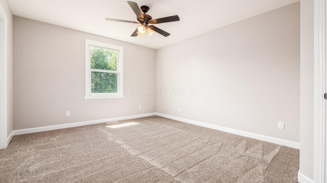 empty room with carpet, baseboards, and ceiling fan