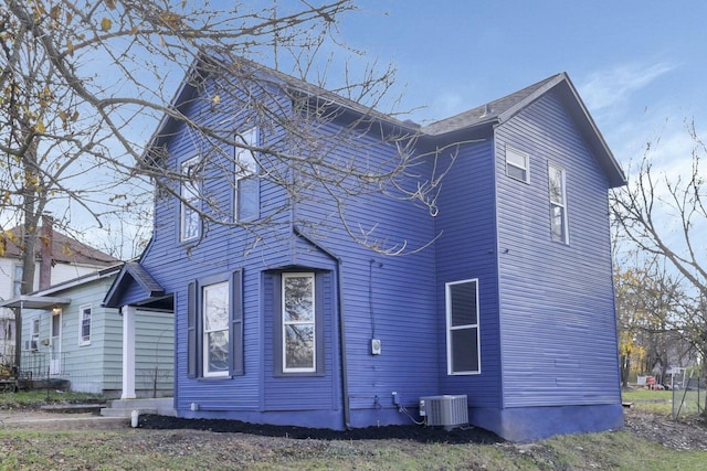 view of side of home featuring central AC unit