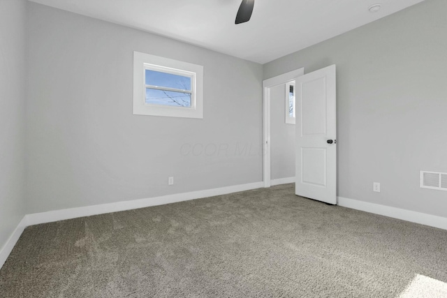 spare room with carpet and ceiling fan