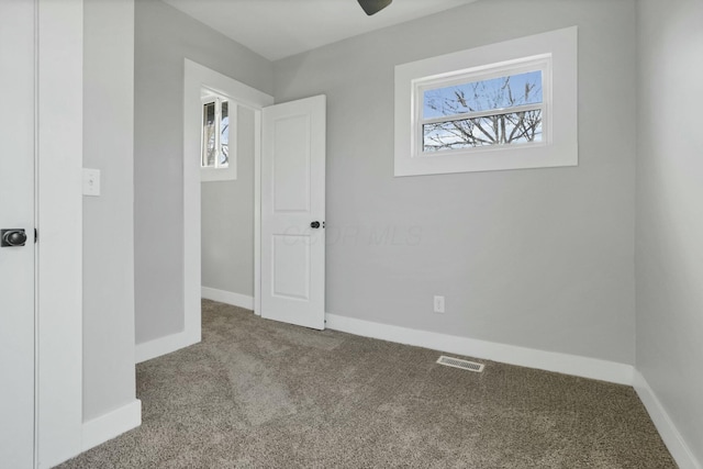 carpeted empty room with ceiling fan