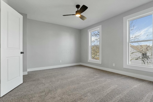 carpeted empty room featuring ceiling fan