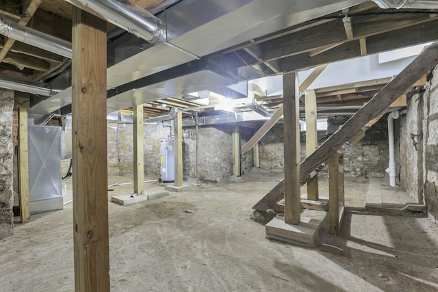 basement featuring heating unit and water heater