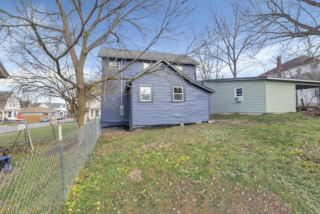 back of house featuring cooling unit and a lawn