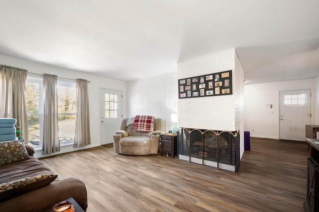 living room featuring hardwood / wood-style floors and a brick fireplace