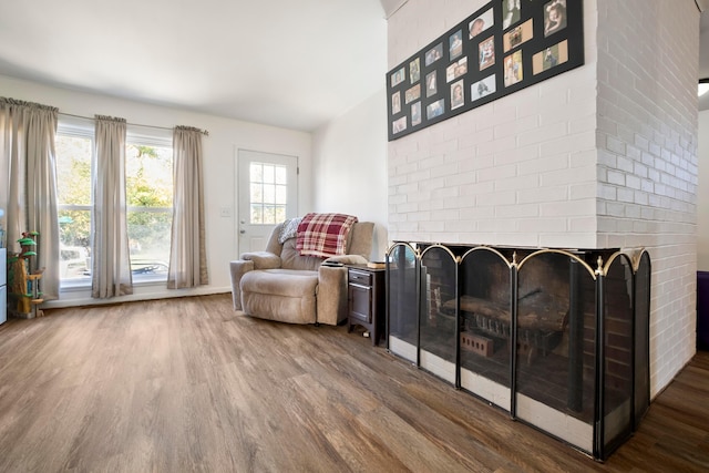 sitting room with hardwood / wood-style flooring and a fireplace