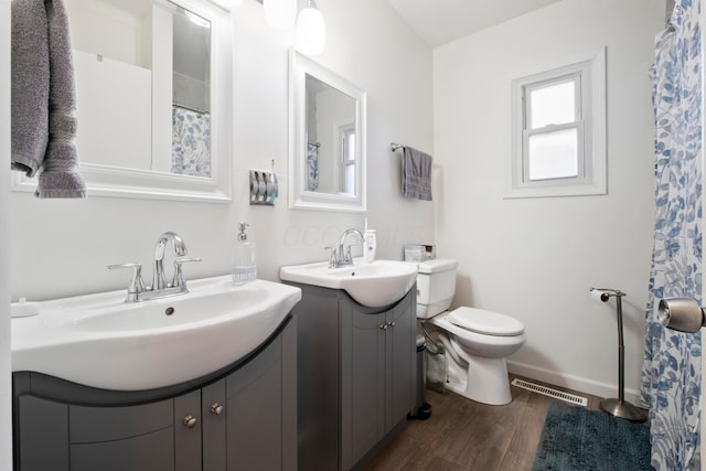 bathroom featuring vanity, hardwood / wood-style flooring, and toilet