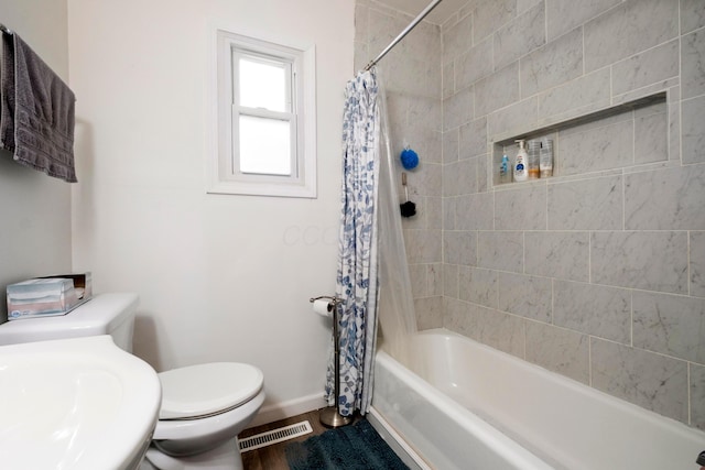 full bathroom featuring sink, hardwood / wood-style floors, shower / tub combo with curtain, and toilet