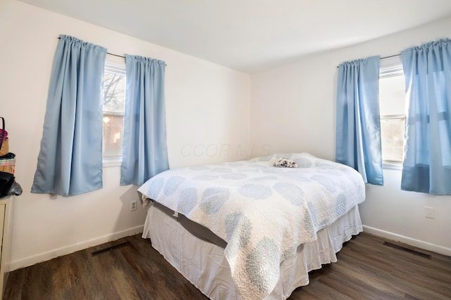 bedroom with dark hardwood / wood-style floors